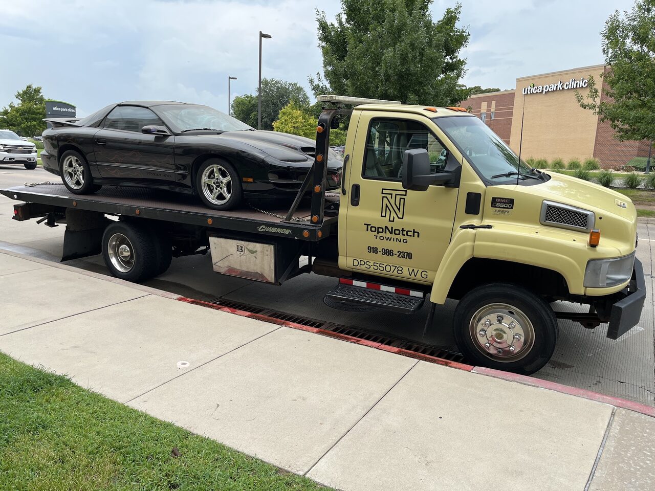 Topnotch Towing flatbed loaded with a Pontiac Trans Am